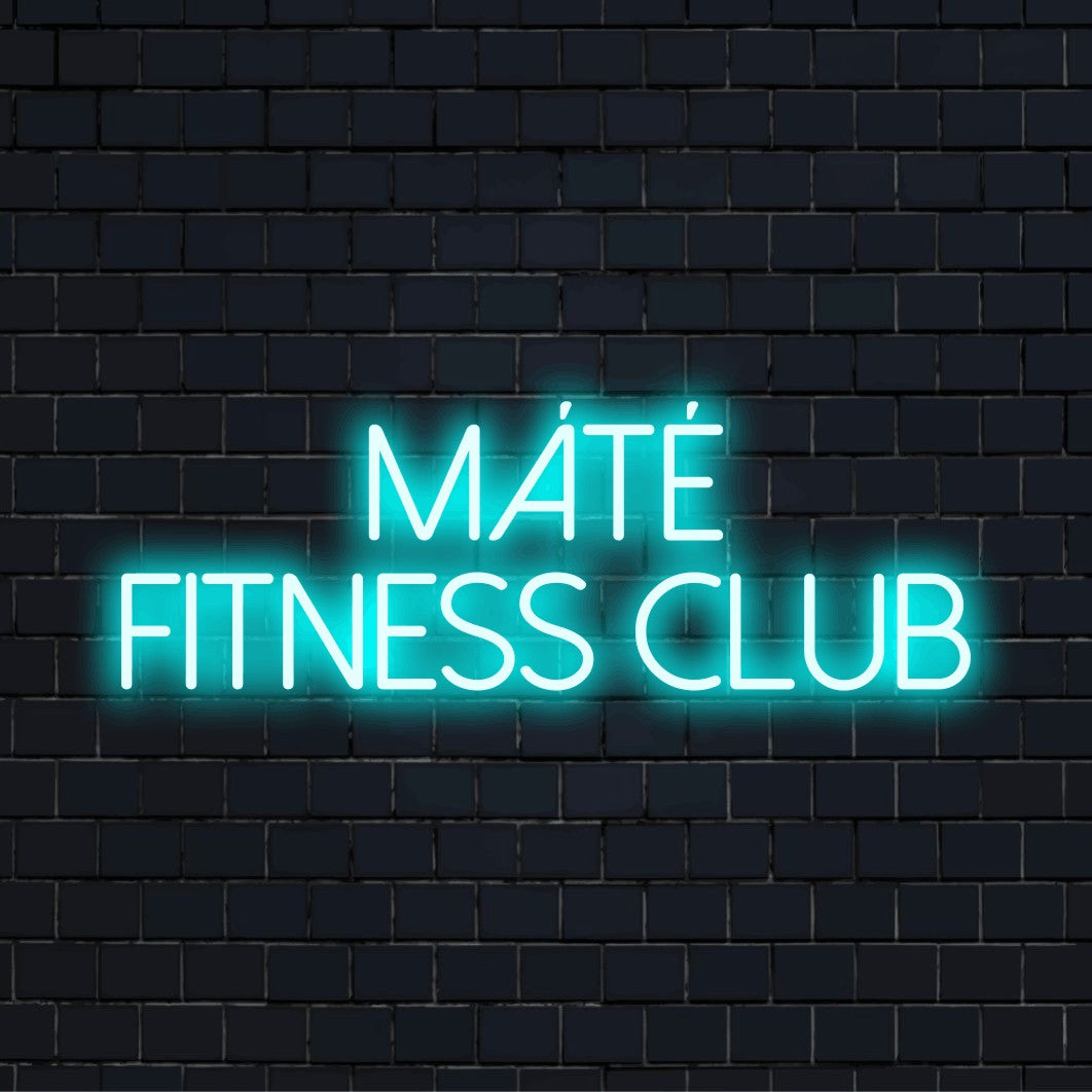 Mate Fitness Club Custom Name Neon Sign, bright neon glow against black brick wall