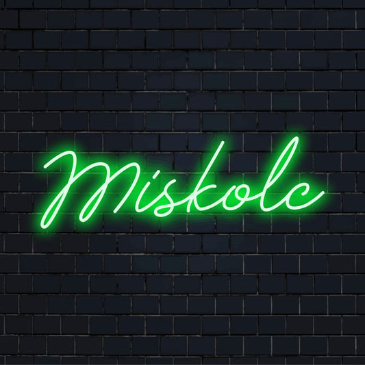 Miskolc LED Neon Sign, glowing neon text on dark brick wall