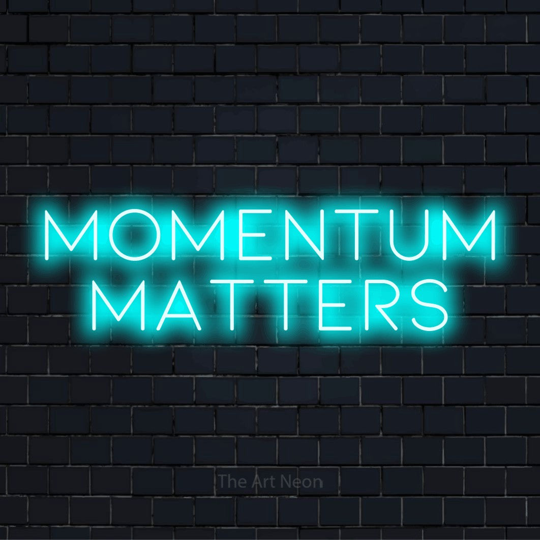 "Momentum Matters" script-style LED neon sign on a black brick wall