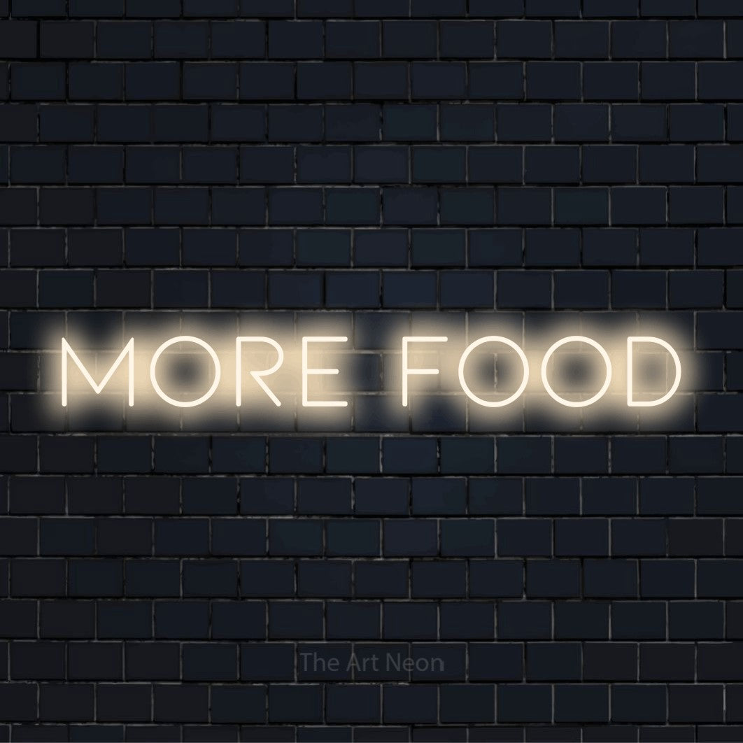 "More Food" LED neon sign on a black brick wall