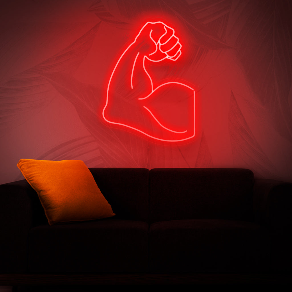 En slående neonskylt som visar upp en muskulös arm som representerar styrka, kraft och kondition.