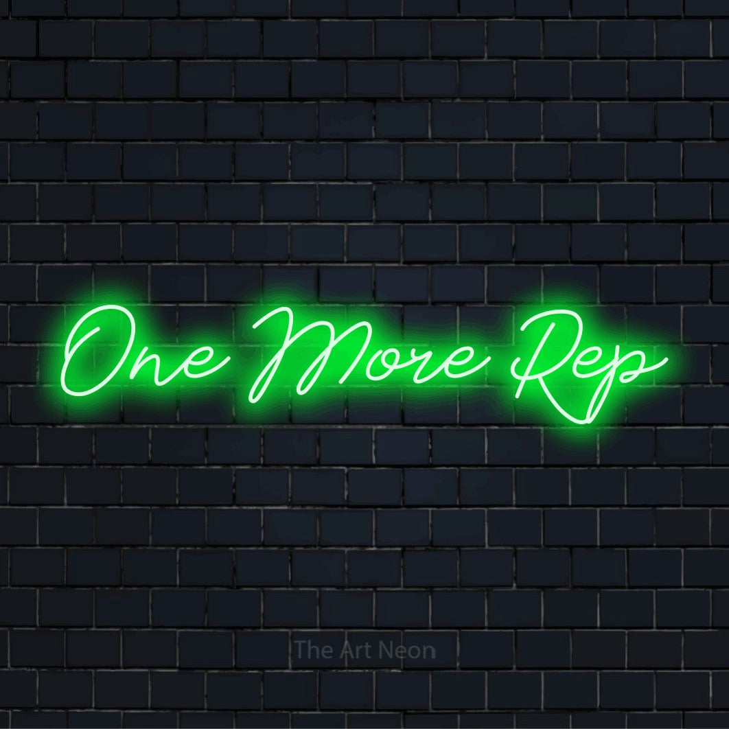 "One More Rep" LED neon sign on a black brick wall