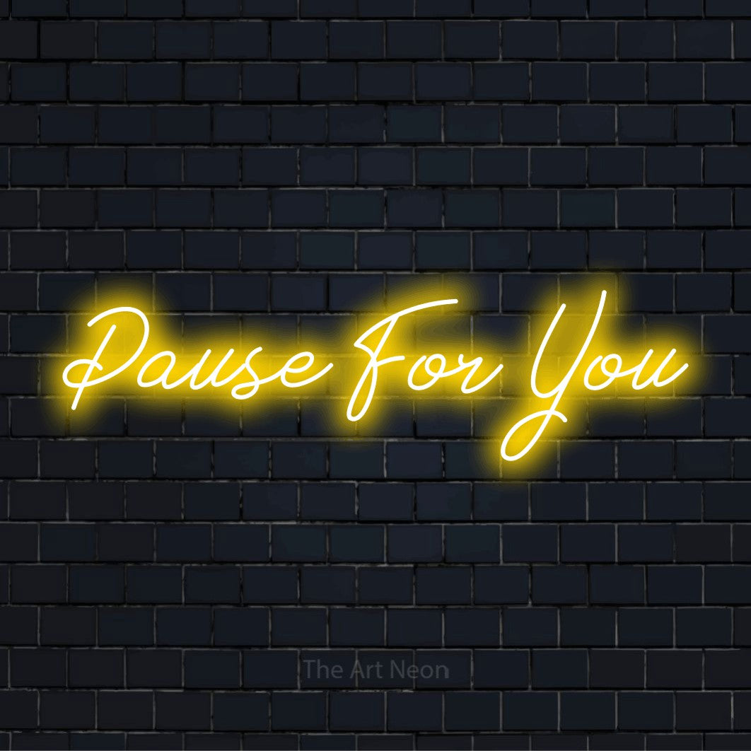 "Pause For You" LED neon sign on a black brick wall