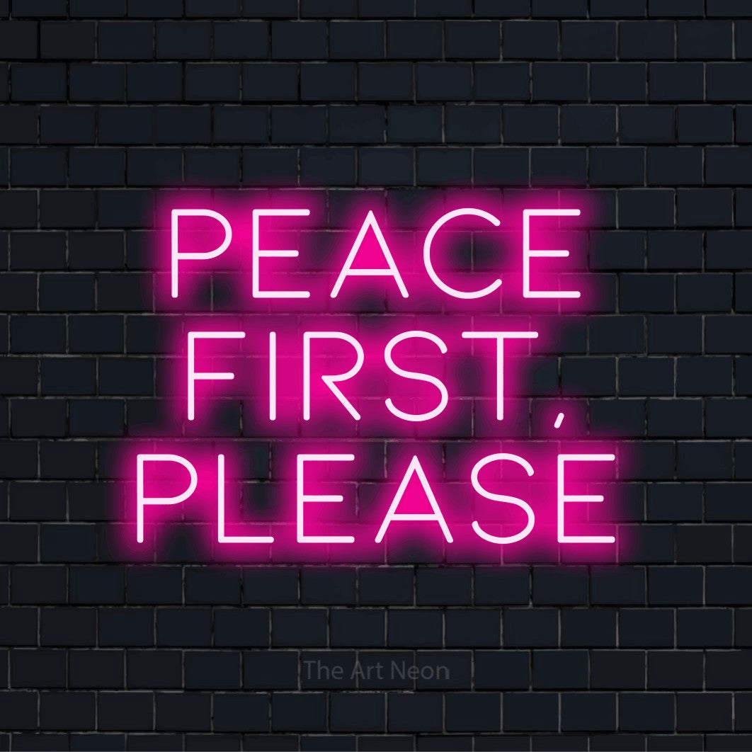 "Peace First, Please" LED neon sign on a black brick wall