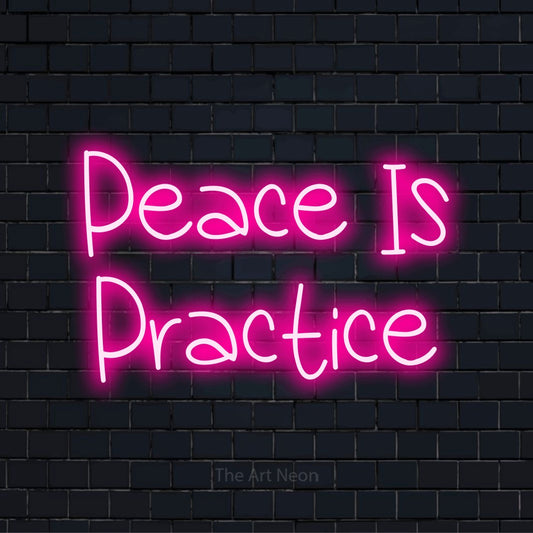 "Peace Is Practice" script-style LED neon sign on a black brick wall