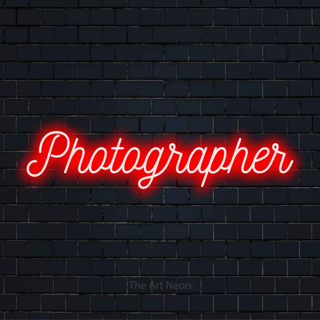 "Photographer" neon text design on a black brick wall
