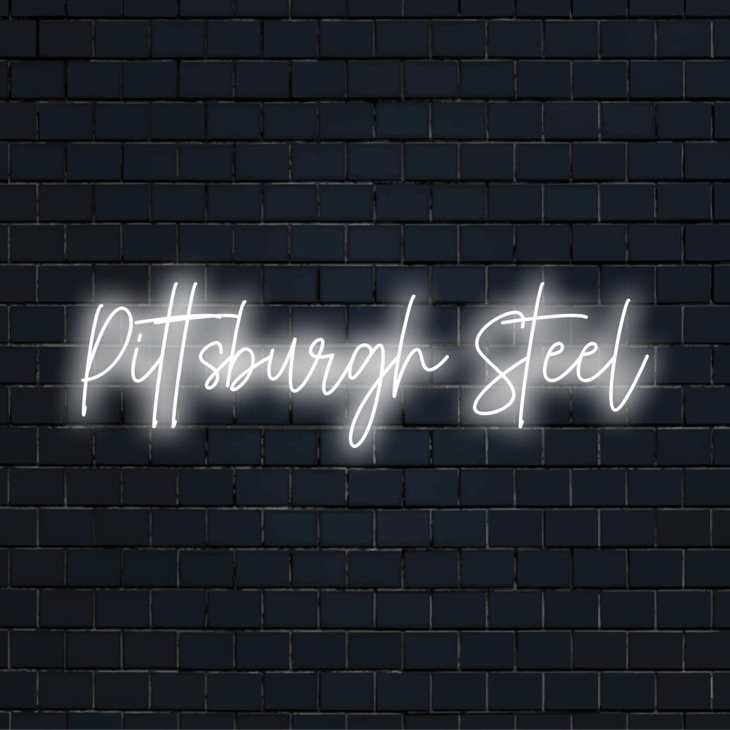 Pittsburgh Steel Neon Light with bright neon lettering on dark brick wall