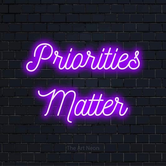 "Priorities Matter" glowing LED neon sign on a black brick wall
