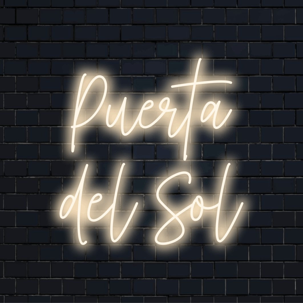 Puerta Del Sol Neon Sign, glowing lettering on dark brick background