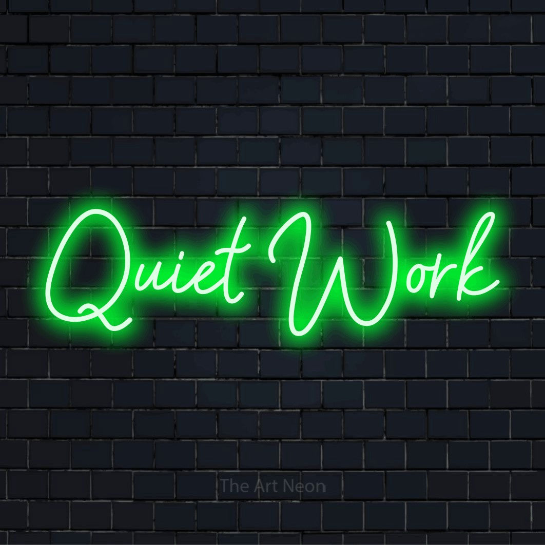 "Quiet Work" glowing LED neon sign on a black brick wall