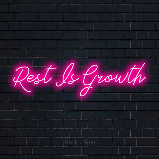 "Rest Is Growth" text design with neon effect on a black brick wall