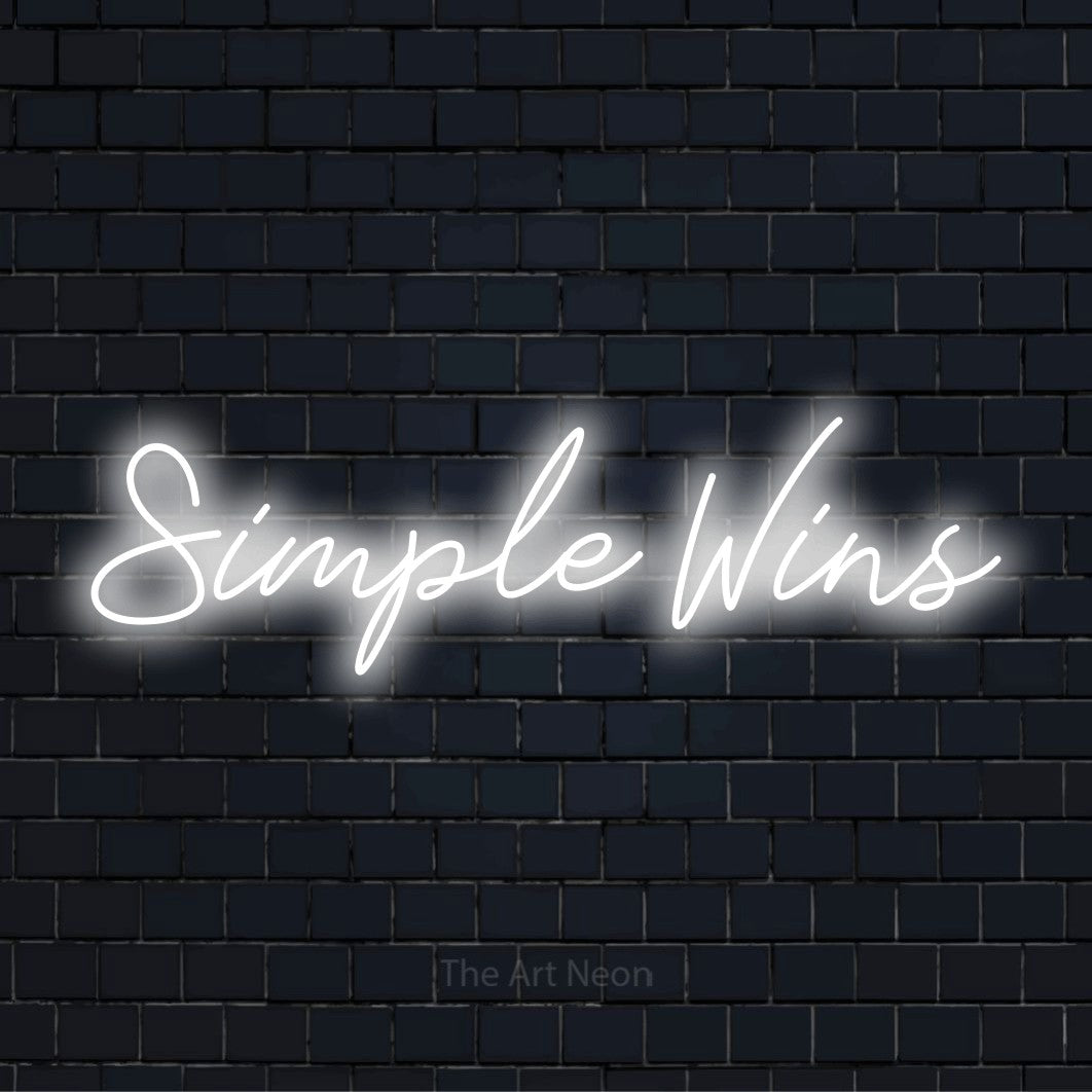 "Simple Wins" neon text design on a black brick wall
