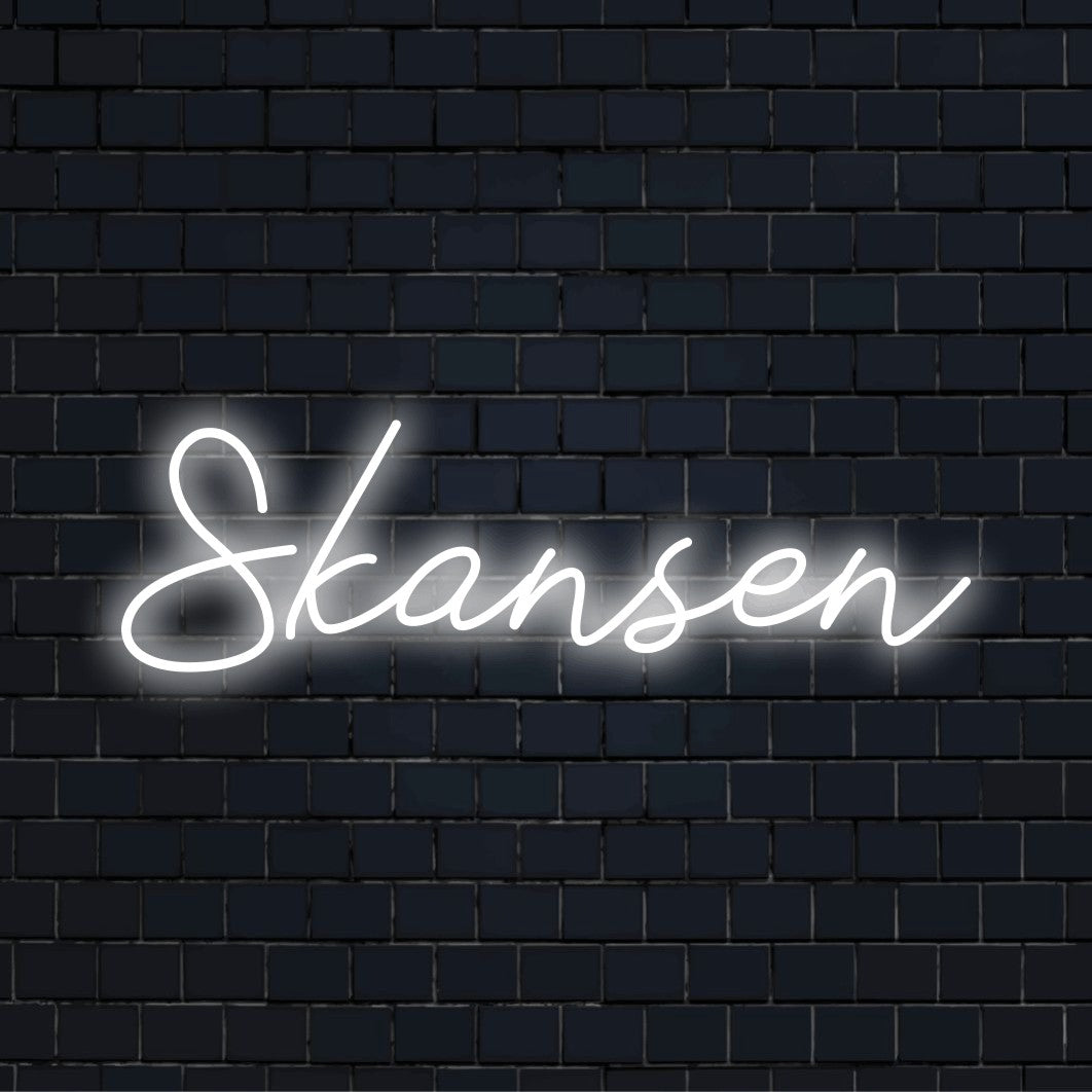 Skansen Neon Light with glowing lettering against brick backdrop