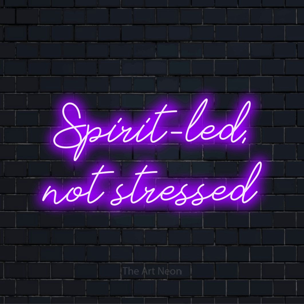 "Spirit-led, Not Stressed" LED neon sign on a black brick wall