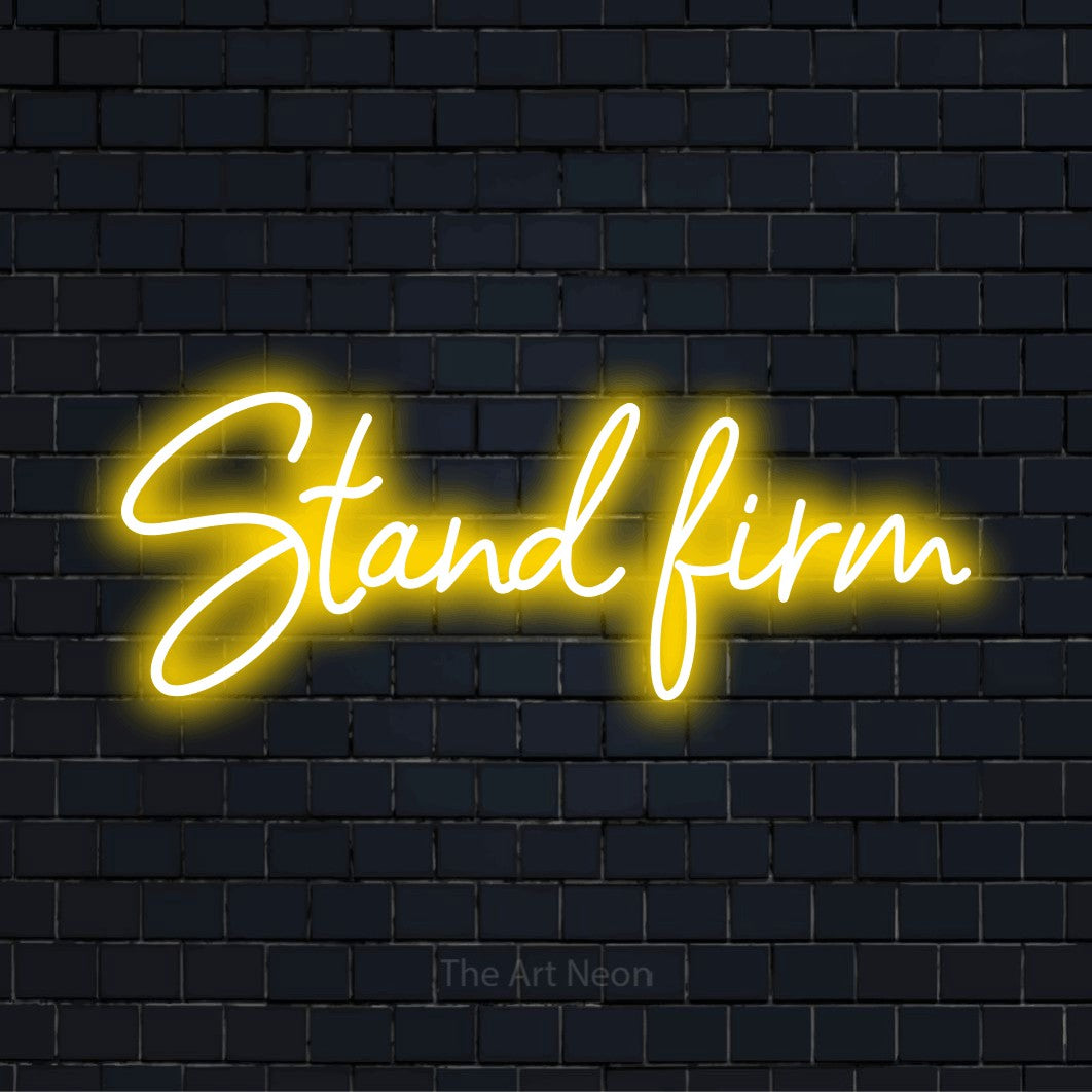 "Stand Firm" text design with neon effect on a black brick wall