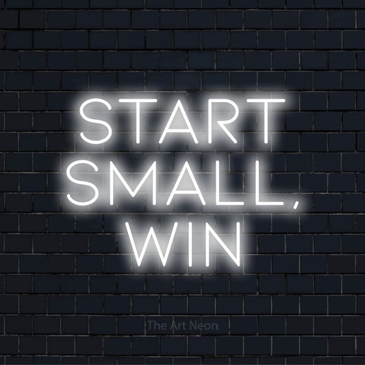 "Start Small, Win" neon text design on a black brick wall