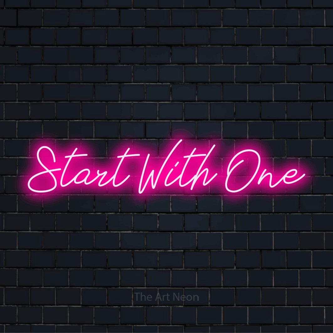 "Start With One" neon text design on a black brick wall