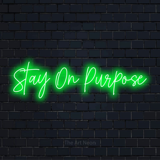 "Stay On Purpose" LED neon sign on a black brick wall