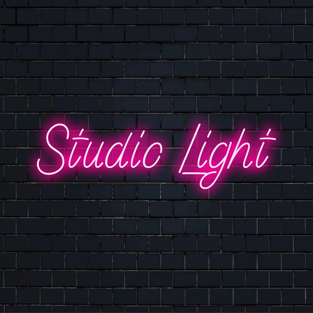 Studio Light Neon Sign, soft neon glow on dark brick wall