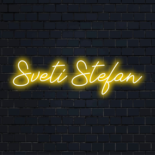 Sveti Stefan Neon Sign, glowing lettering against black brick wall