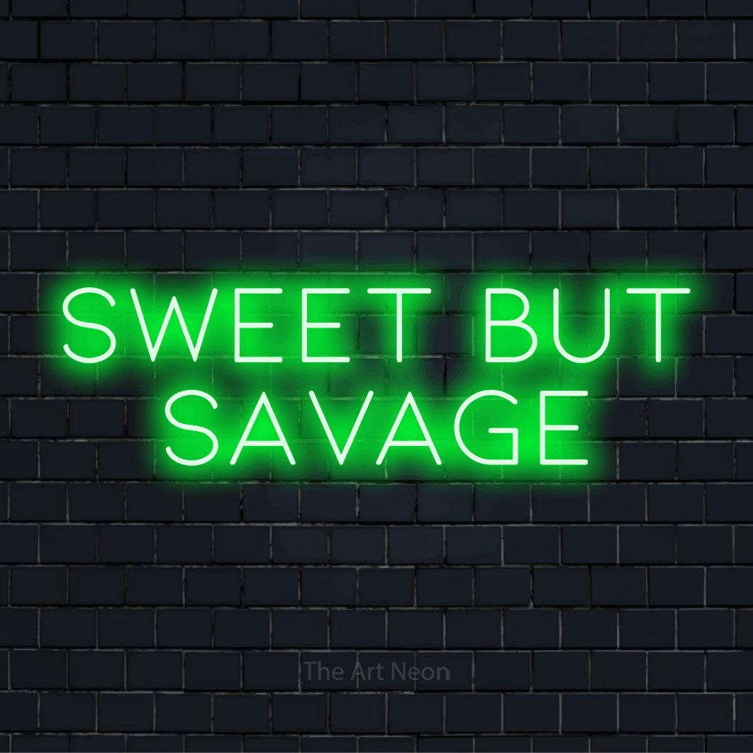 "Sweet But Savage" neon text design on a black brick wall