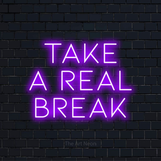 "Take A Real Break" LED neon sign on a black brick wall