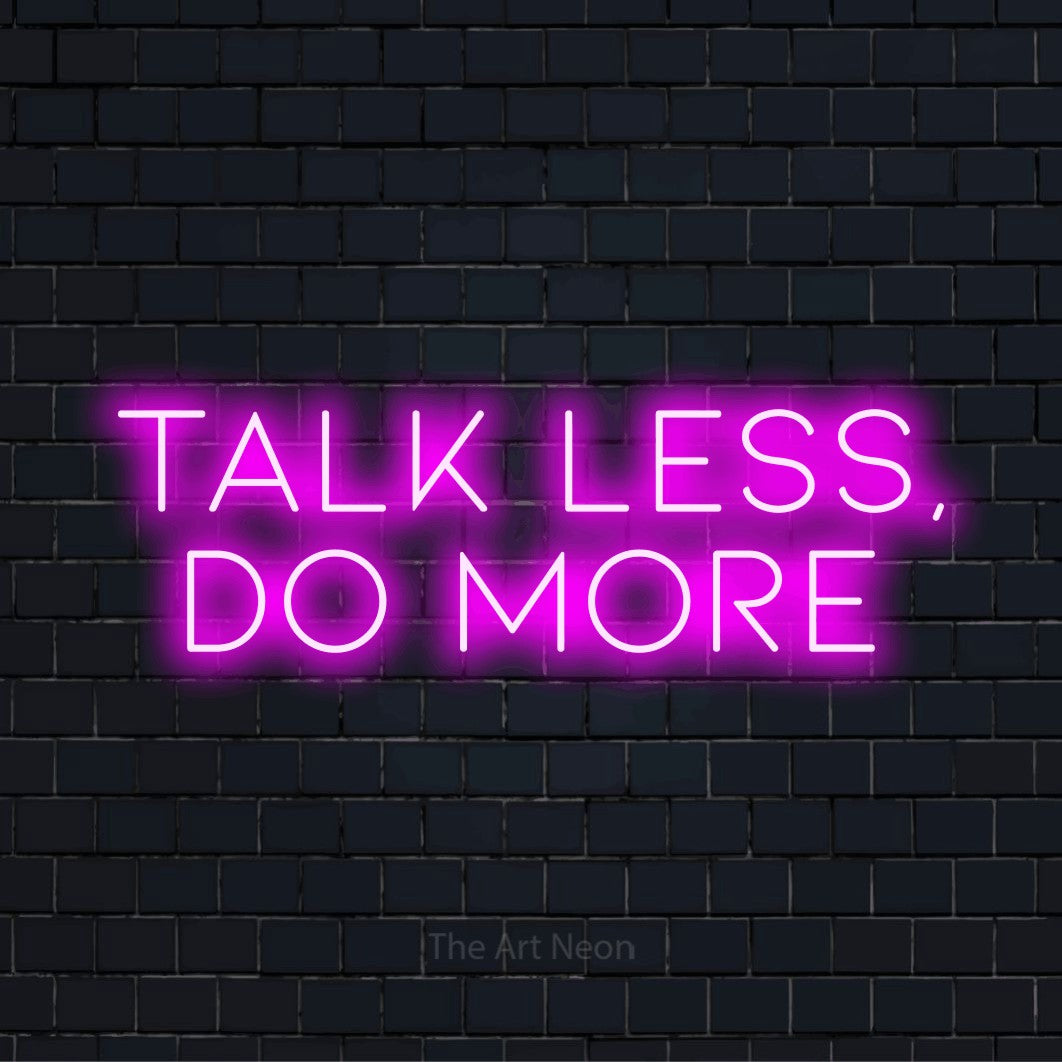 "Talk Less, Do More" neon text design on a black brick wall