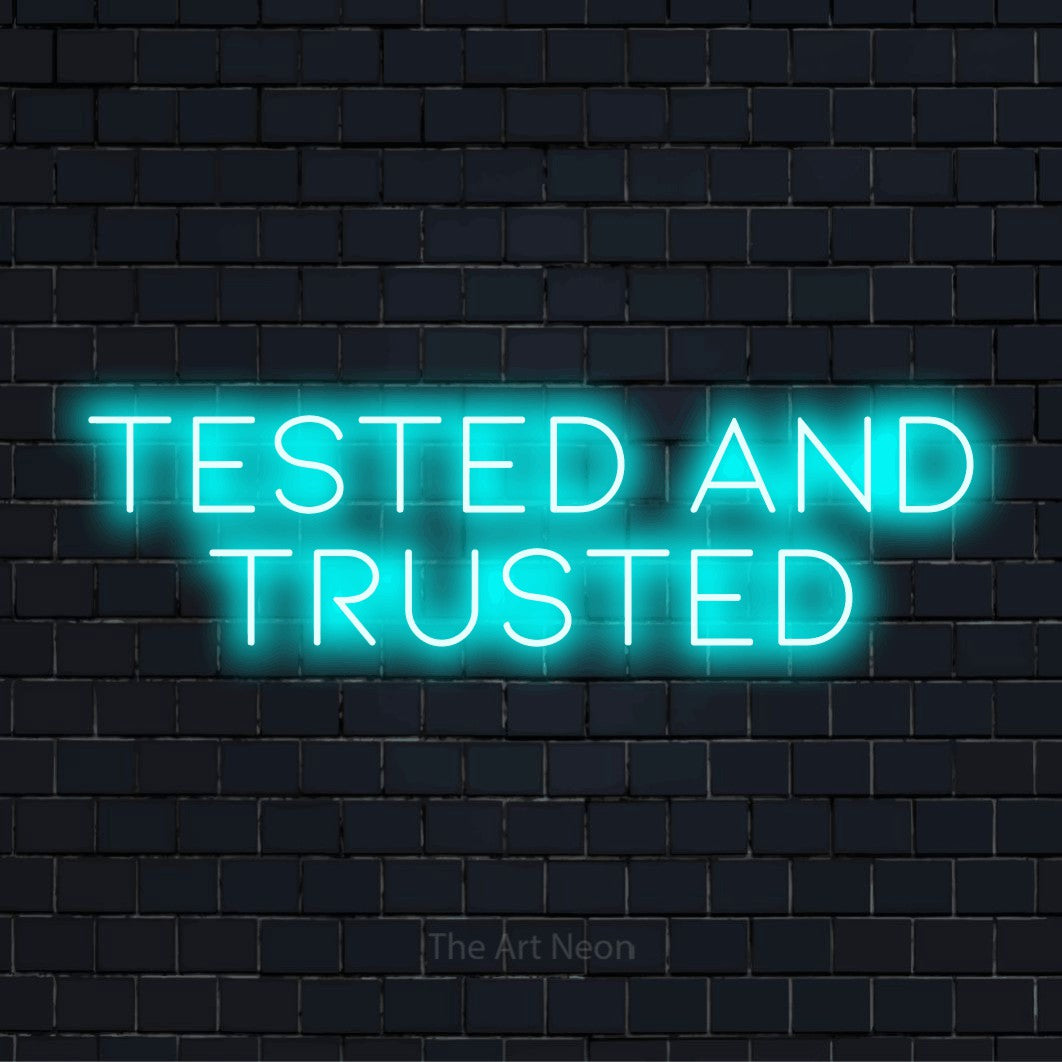 "Tested And Trusted" glowing LED neon sign on a black brick wall