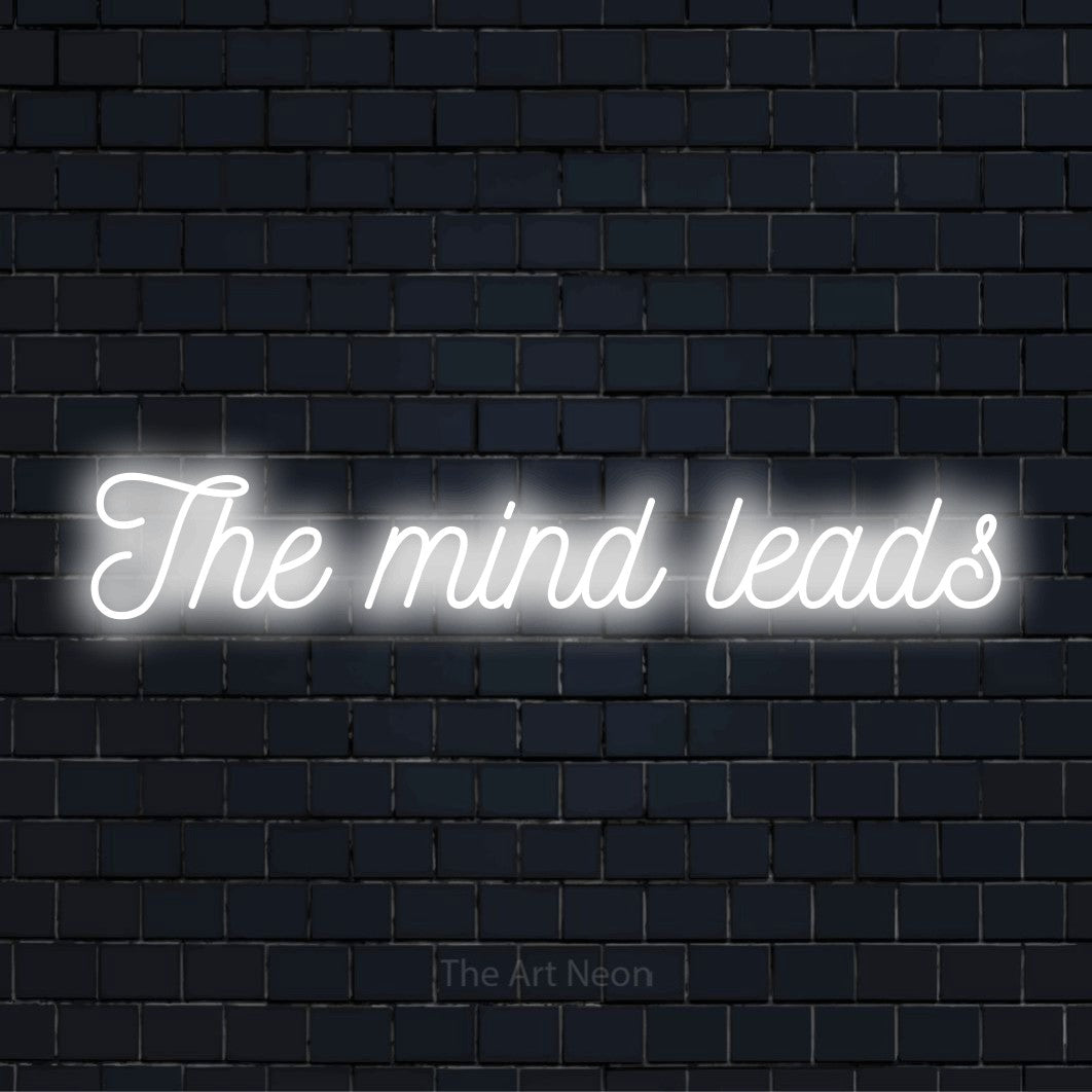 "The Mind Leads" text design with neon effect on a black brick wall