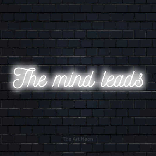 "The Mind Leads" text design with neon effect on a black brick wall