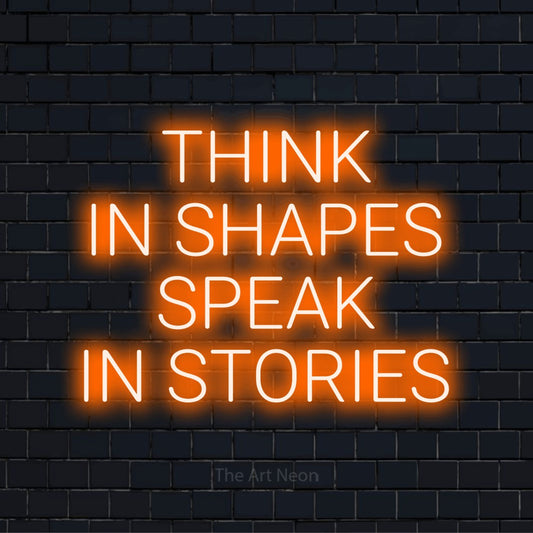 "Think In Shapes Speak In Stories" text design with neon effect on a black brick wall