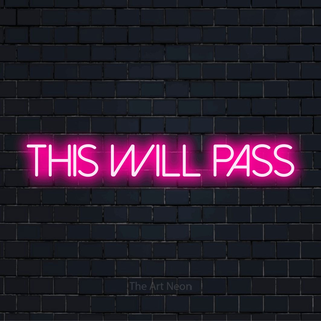 "This Will Pass" LED neon sign on a black brick wall