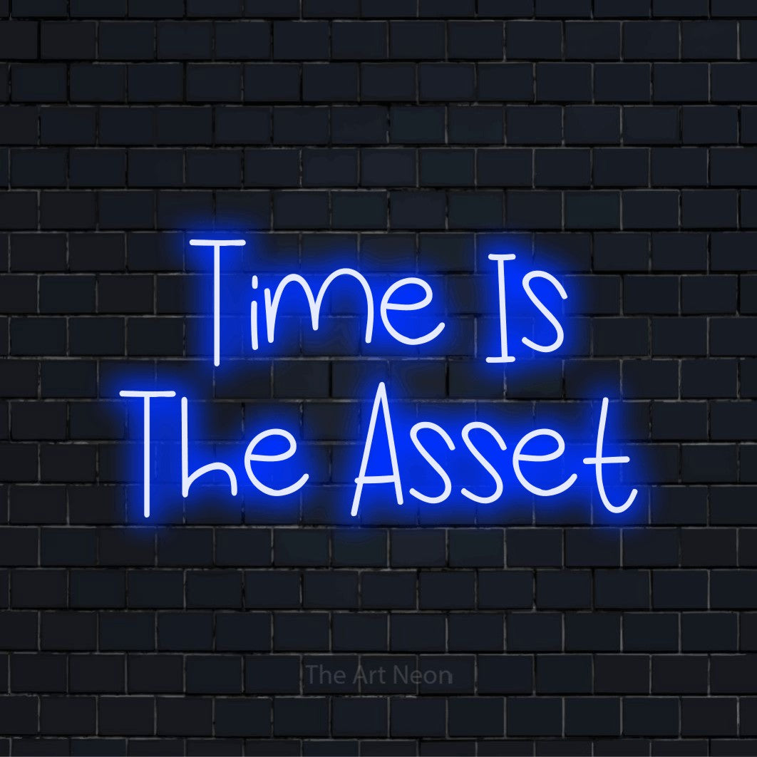 "Time Is The Asset" LED neon sign on a black brick wall