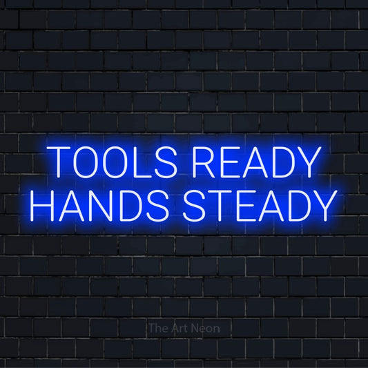 "Tools Ready Hands Steady" glowing LED neon sign on a black brick wall