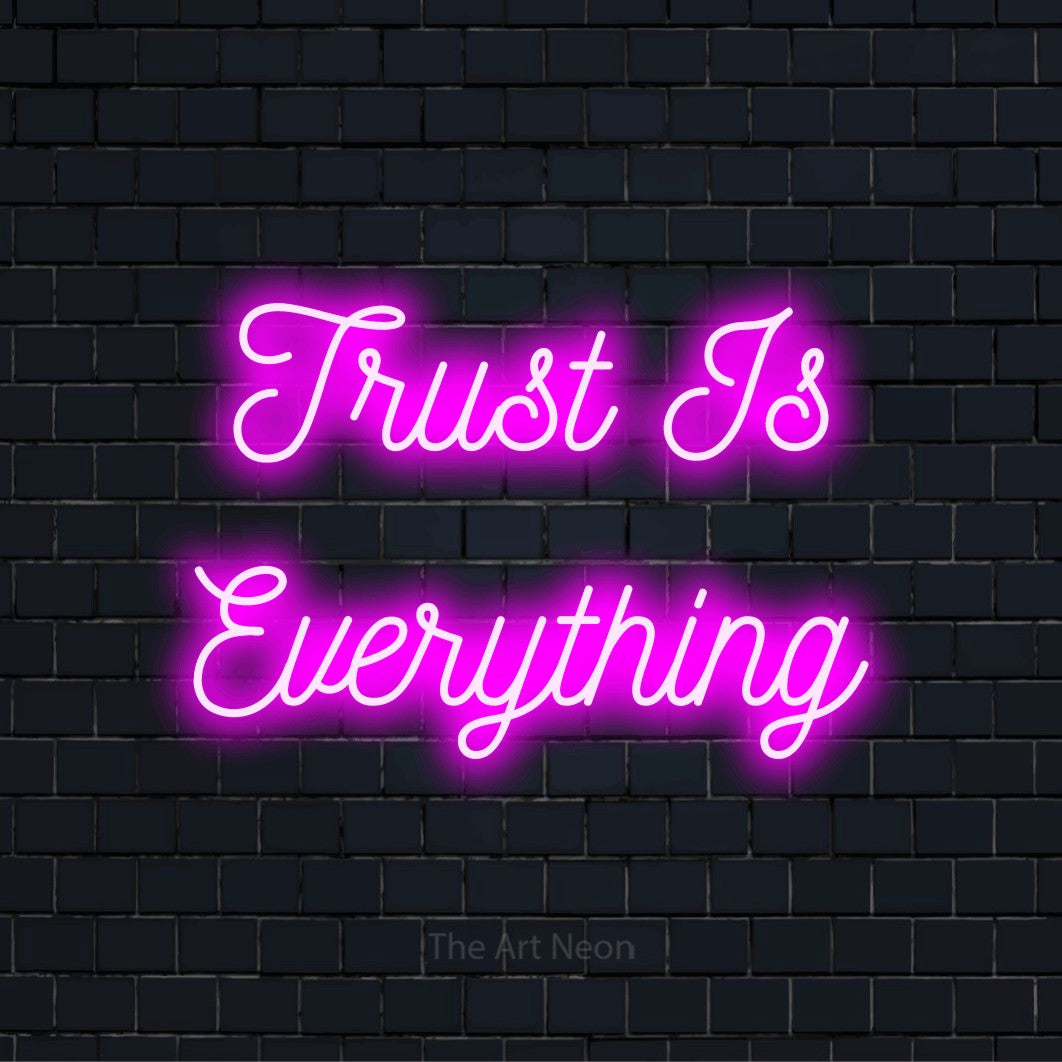 "Trust Is Everything" LED neon sign on a black brick wall
