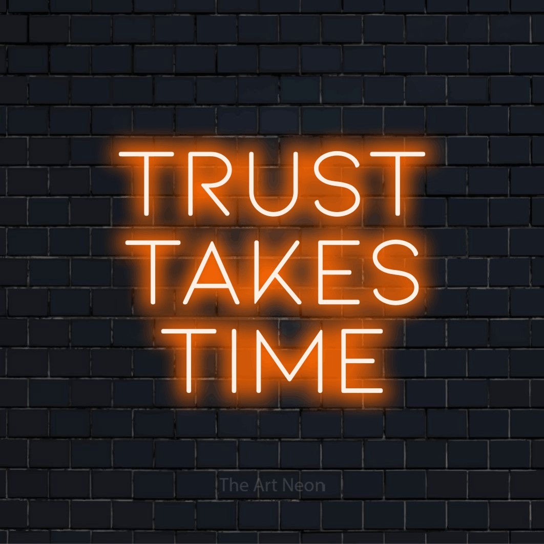 "Trust Takes Time" script-style LED neon sign on a black brick wall