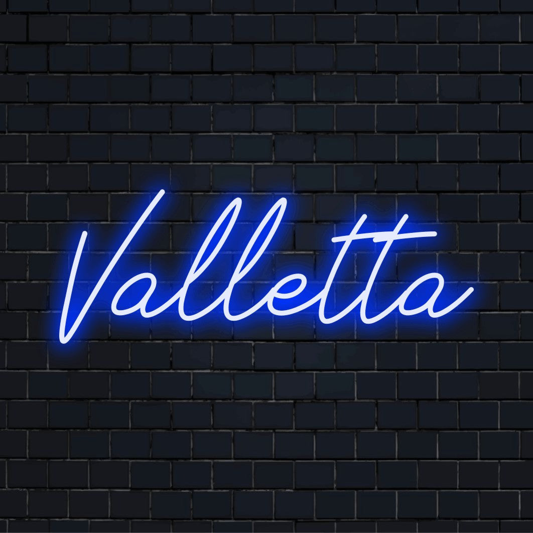 Valletta Neon Light with neon text light on dark brick wall