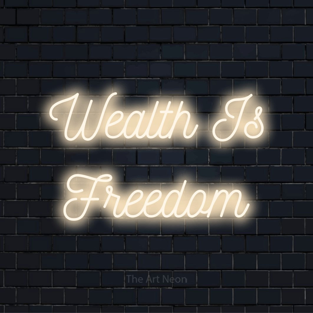 "Wealth Is Freedom" glowing LED neon sign on a black brick wall