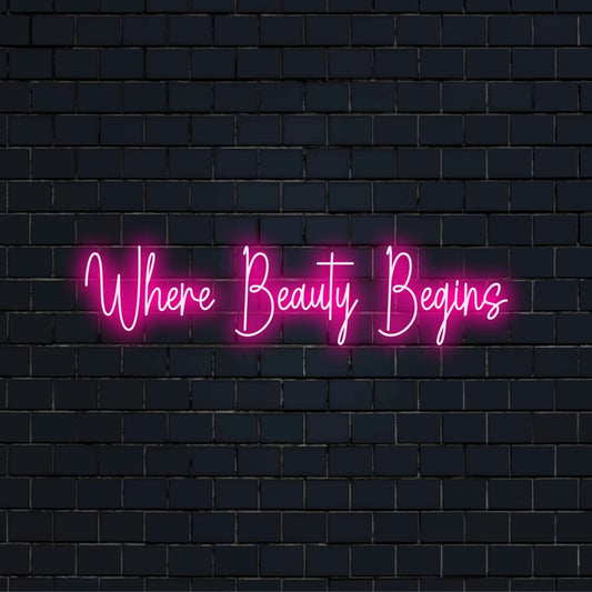Where Beauty Begins Neon Light with glowing wall decor against black brick wall