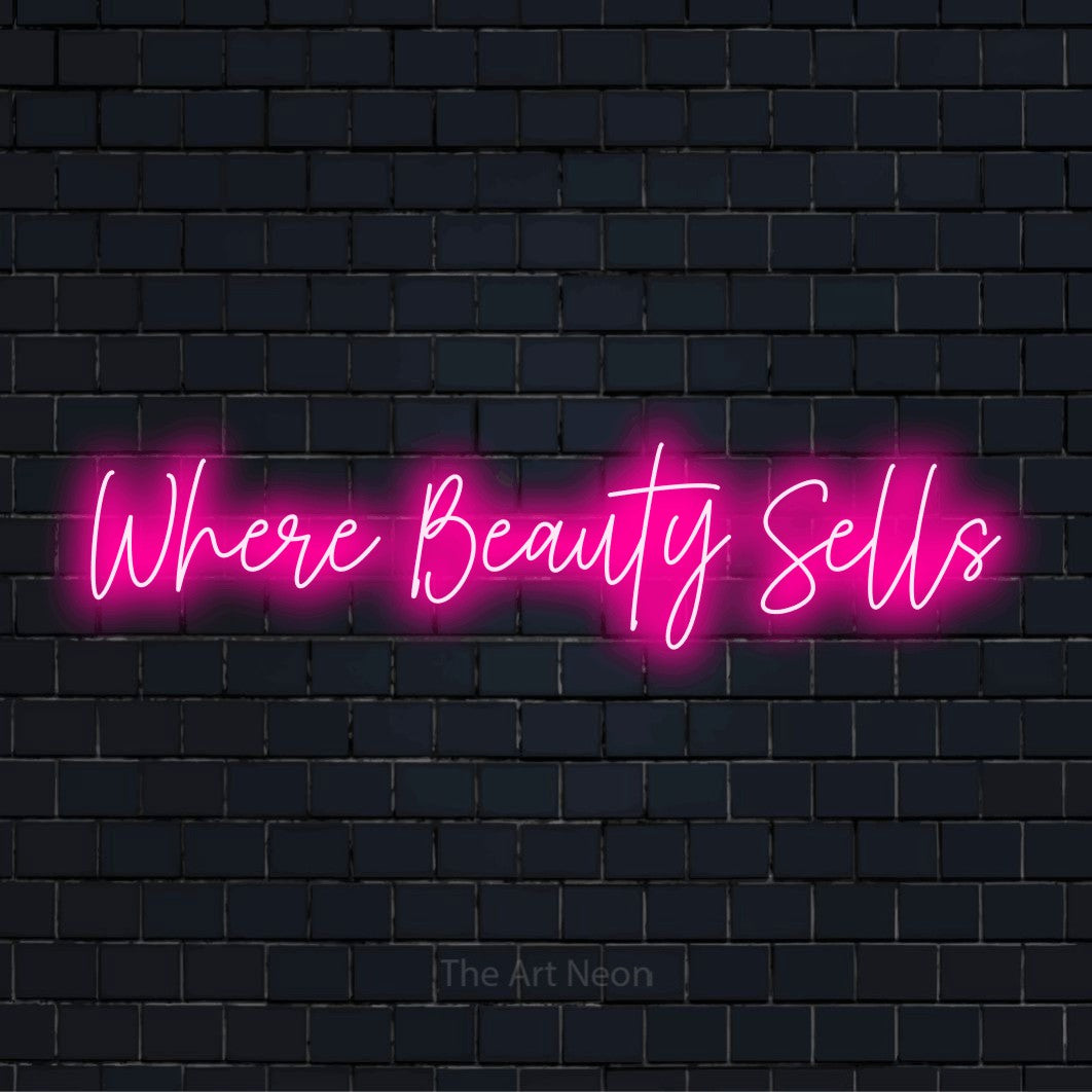 "Where Beauty Sells" neon text design on a black brick wall
