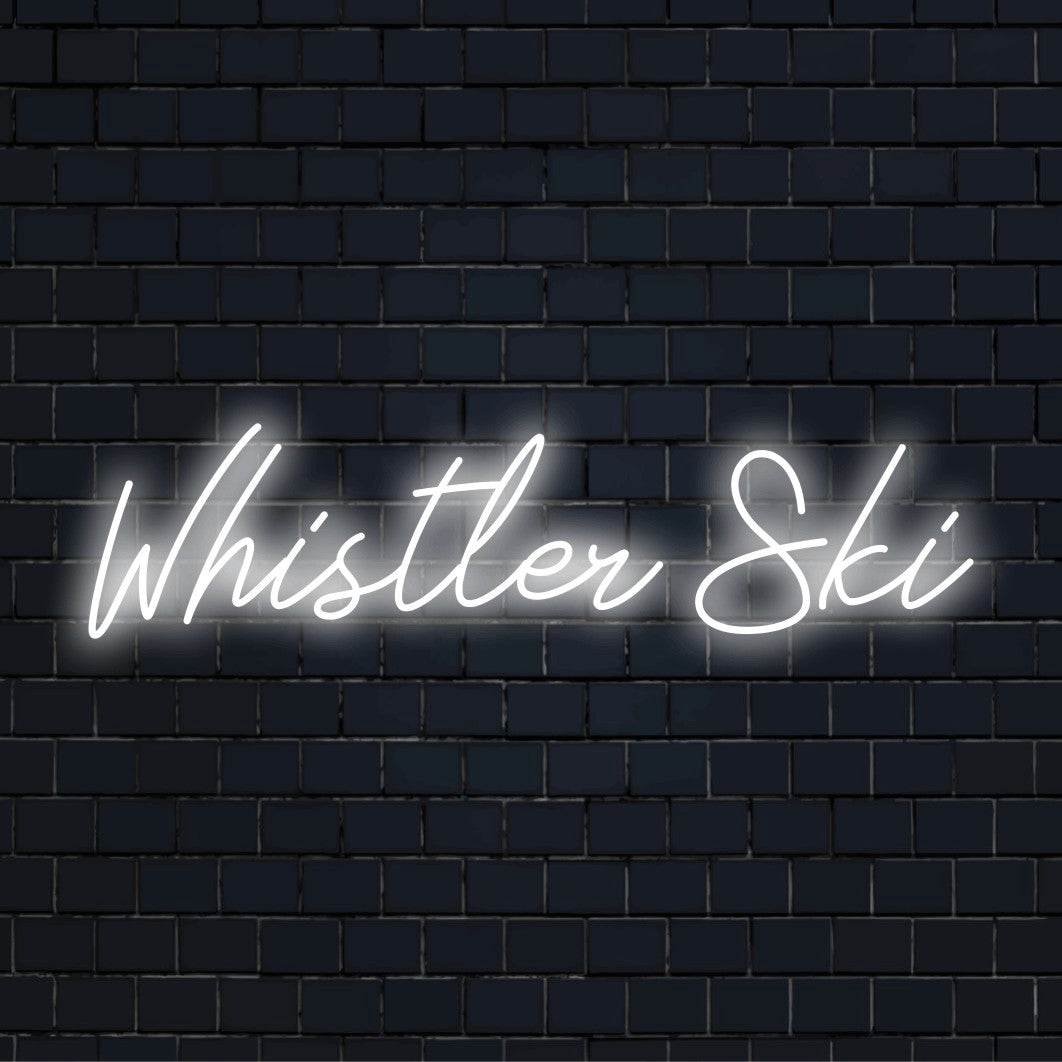 Whistler Ski LED Neon Sign, glowing lettering on dark brick wall