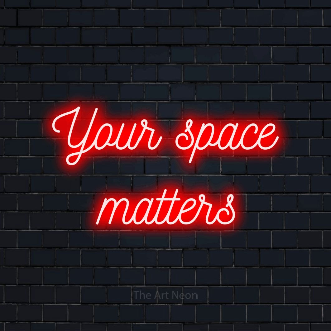 "Your Space Matters" glowing LED neon sign on a black brick wall